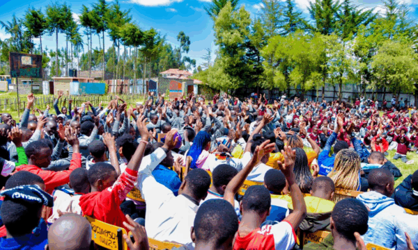 Students in Kinangop, Kenya excitedly wait for books from the Friends of the Joliet Public Library.